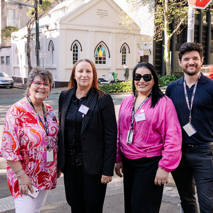 Mission Australia Centre Surry Hills team stands together on the street for the 50th anniversary.