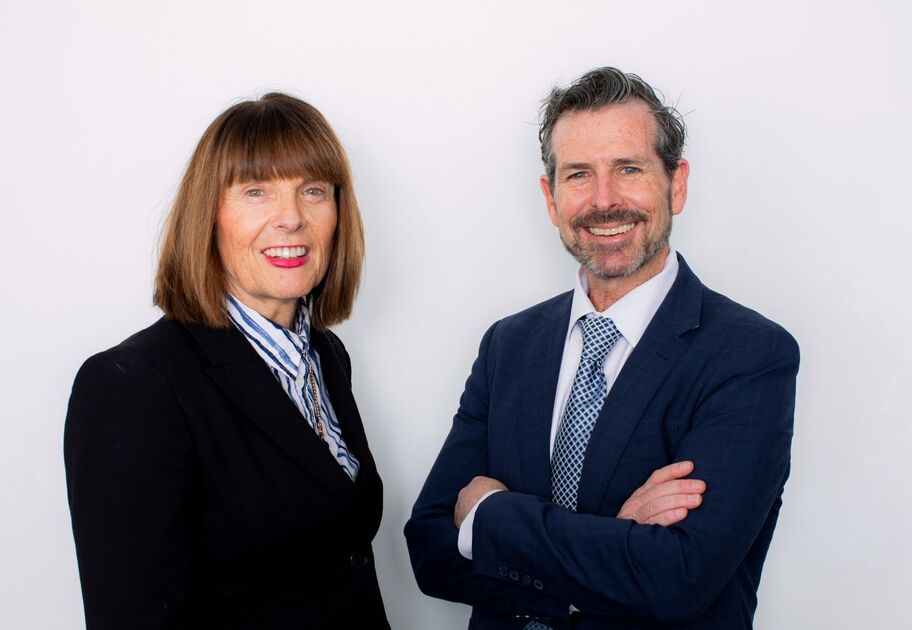Portrait of Mission Australia CEO, Sharon Callister, standing next to Deputy CEO, Ben Carblis