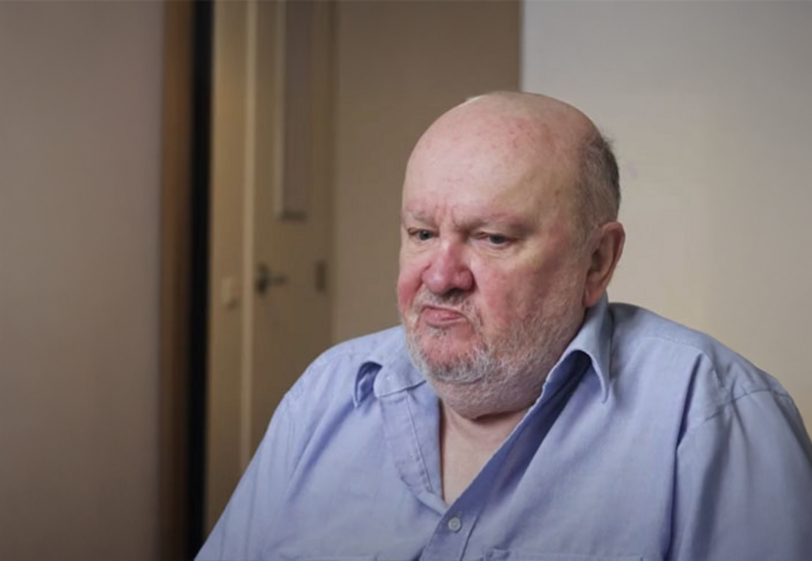 Portrait of Miles, a Mission Australia client, sitting indoors, featured in the Summer 2025 Impact Report